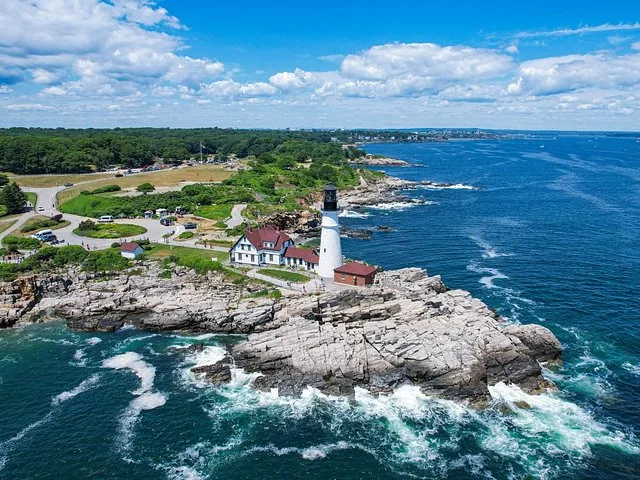 Aerial view of Portland Head Light situated on a rocky coastline by the ocean